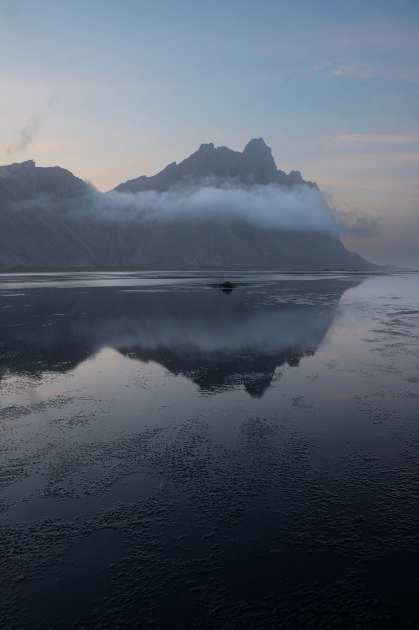 mountains reflected in shallow, still water